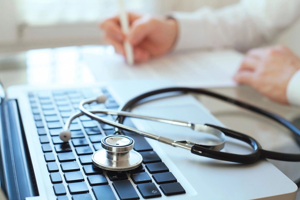 stethoscope sitting on laptop keyboard